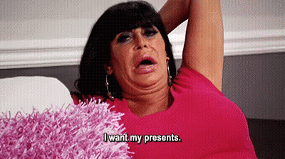 Woman In Pink Shirt Making Funny Face On Couch GIF