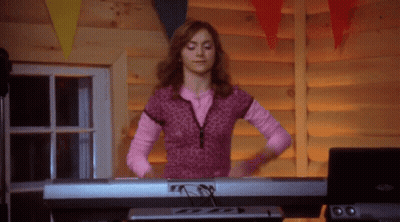 Woman In Pink Shirt Playing Piano GIF