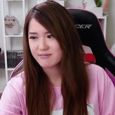 Woman In Pink Shirt Sitting In Chair With Cer GIF