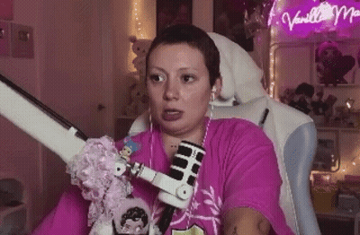 Woman In Pink Shirt Sitting With Microphone And Headphones GIF