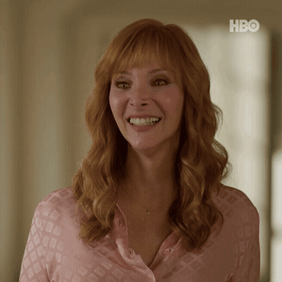 Woman In Pink Shirt Smiling At HBO Sign GIF