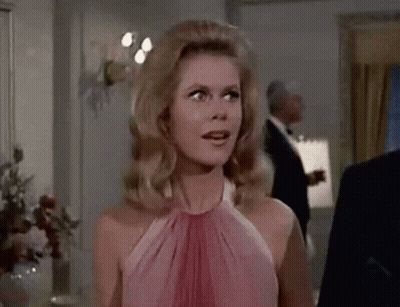 Woman In Pink Shirt Talking On Telephone GIF