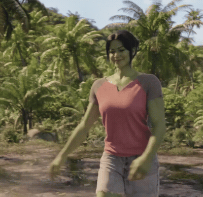 Woman In Pink Shirt Walking Through Lush Green Forest GIF