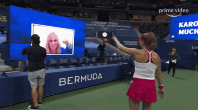 Woman In Pink Skirt In Front Of Bermuda Banner GIF