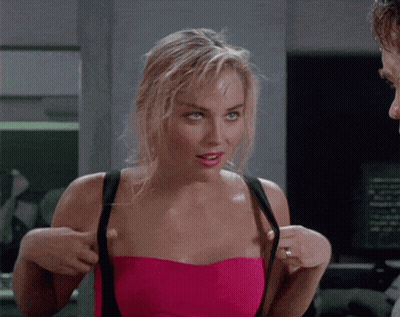Woman In Pink Strapless Top Adjusting Bra Straps GIF