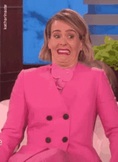 Woman In Pink Suit Making Funny Face GIF
