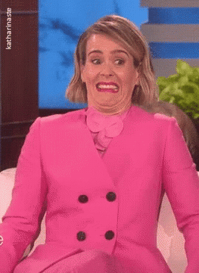 Woman In Pink Suit Making Funny Face GIF