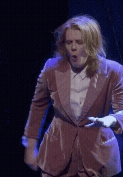 Woman In Pink Suit On Stage GIF
