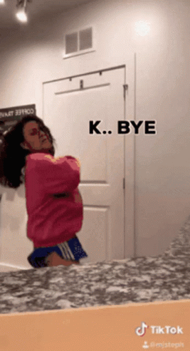 Woman In Pink Sweater And Blue Shorts GIF