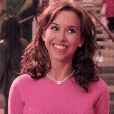 Woman In Pink Sweater And Necklace Smiling GIF