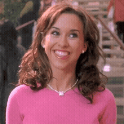 Woman In Pink Sweater And Necklace Smiling GIF