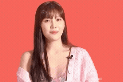 Woman In Pink Sweater And Pink Top Smiling GIF