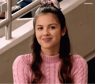 Woman In Pink Sweater And Scarf Smiling GIF