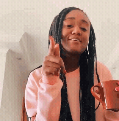 Woman In Pink Sweater Holding Coffee GIF