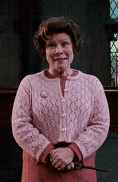 Woman In Pink Sweater Holding Wand GIF