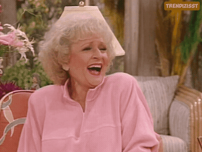 Woman In Pink Sweater Laughing In Front Of Trendizsst Sign GIF