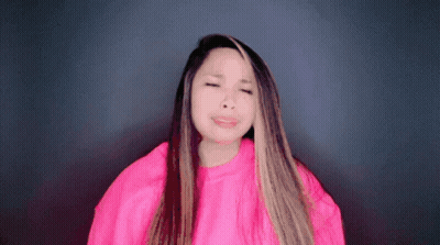 Woman In Pink Sweater Making Funny Face GIF