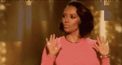 Woman In Pink Sweater Making Funny Face Gold Background GIF