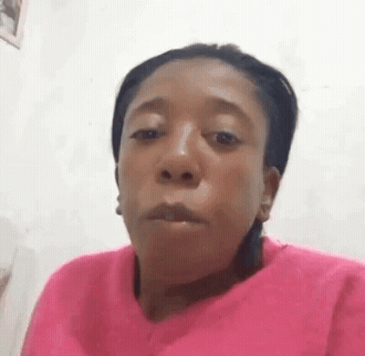 Woman In Pink Sweater Making Funny Face GIF