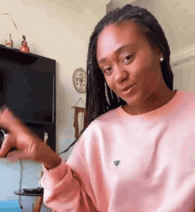 Woman In Pink Sweater Making Funny Face GIF