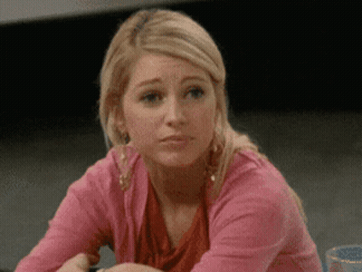Woman In Pink Sweater Making Sad Face GIF