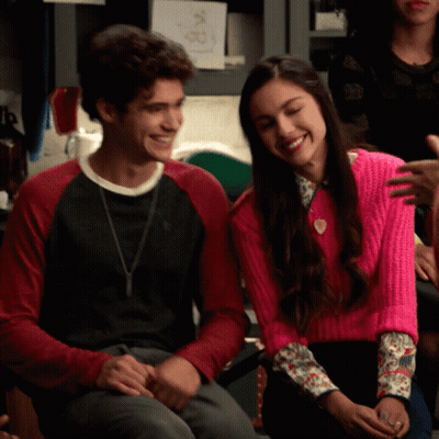Woman In Pink Sweater Next To Man In Black Shirt GIF