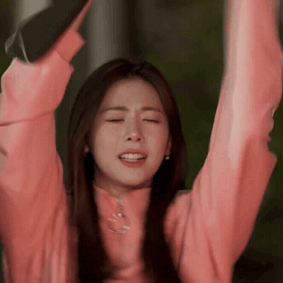 Woman In Pink Sweater Raising Arms GIF