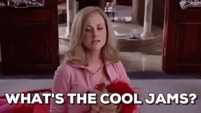 Woman In Pink Sweater Sitting On Bed Talking GIF