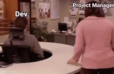 Woman In Pink Sweater Standing By Man In Wheelchair At Desk GIF