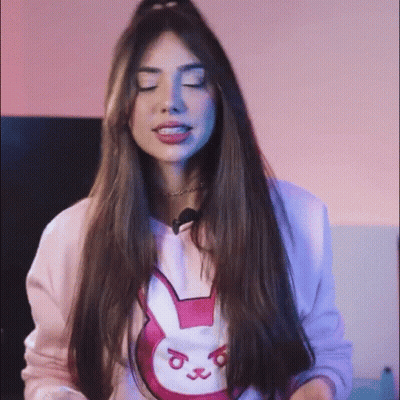 Woman In Pink Sweater With Bunny Eyes Closed GIF