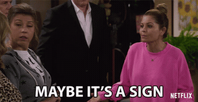 Woman In Pink Sweatshirt Saying Maybe It's A Sign GIF