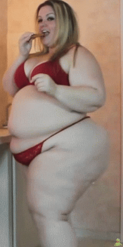 Woman In Pink Tank Top And Black Pants In Front Of Building 411 GIF