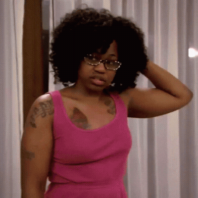 Woman In Pink Tank Top And Glasses Holding Hair GIF