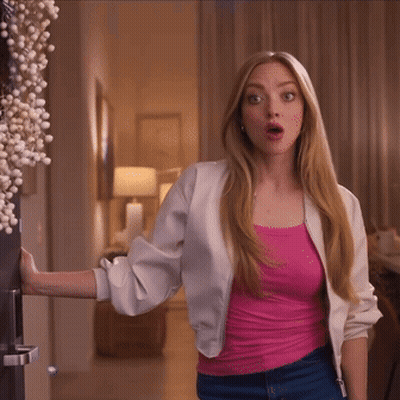 Woman In Pink Tank Top And White Jacket By Door GIF