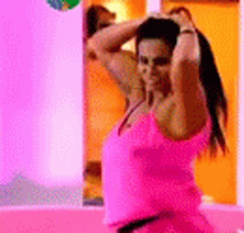 Woman In Pink Tank Top Before Mirror GIF