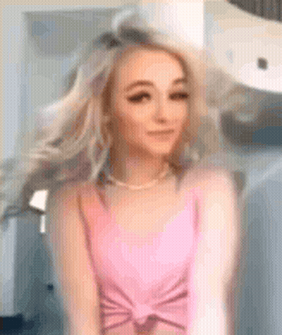 Woman In Pink Tank Top Hair Blowing In Front Of Mirror GIF