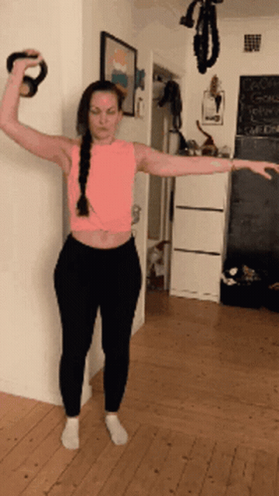 Woman in Pink Tank Top Holding Kettlebell