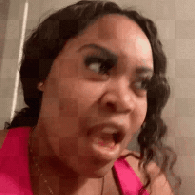 Woman In Pink Tank Top Making Funny Face GIF