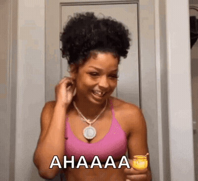 Woman In Pink Tank Top Smiling Holding Candle GIF