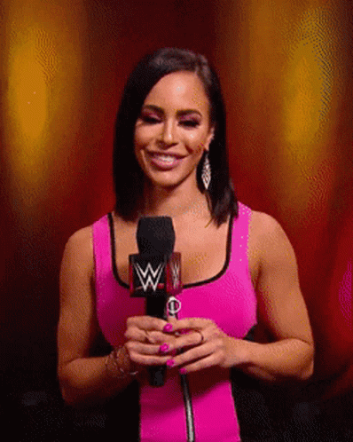 Woman In Pink Tank Top Smiling Holding Microphone W GIF