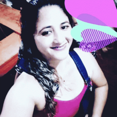 Woman In Pink Tank Top Smiling With Purple Heart GIF