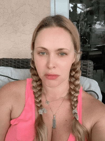 Woman In Pink Tank Top With Braids And I Love You Pendant GIF