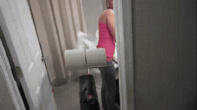 Woman In Pink Tank Top With Toilet Paper GIF