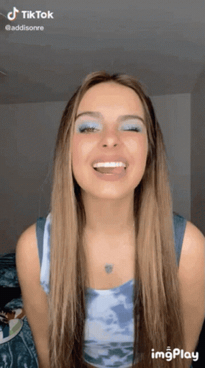 Woman In Pink Tie Dye Hoodie Looking At Camera GIF