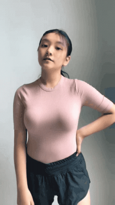 Woman In Pink Top And Black Shorts GIF