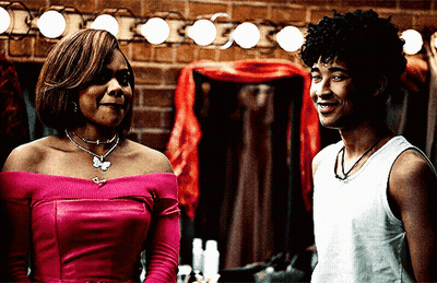 Woman In Pink Top And Man In White Tank Top Smiling GIF
