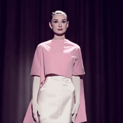 Woman In Pink Top And White Skirt On Stage GIF