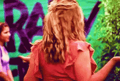Woman In Pink Top By Green Wall Rev GIF