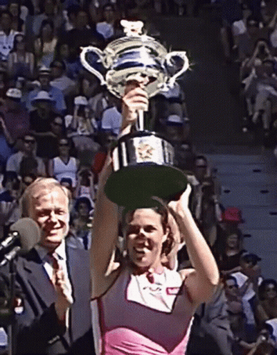 Woman In Pink Top Holding Trophy GIF