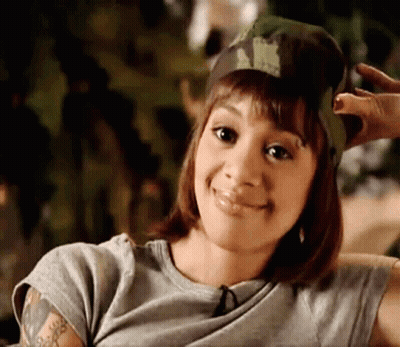 Woman In Pink Top Looking At Mirror GIF